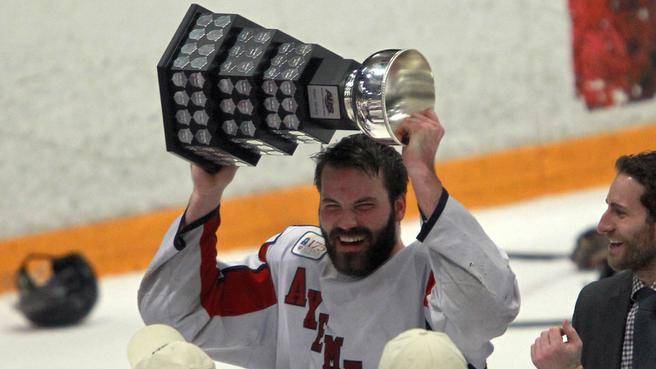 Acadia defenceman Leo Jenner lifts the trophy after the Axemen won the AUS men’s hockey championship over the Saint Mary’s Huskies on March 10. (TIM KROCHAK / Staff) 